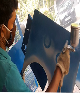 Applying fresh paint on the rebuilt chassis.